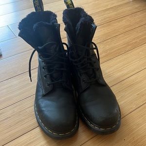 Black shearling lined Dr. Martens boots. Very worn in, some scuffs on toe.